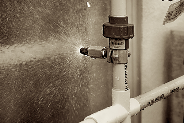 FTL technician performing an ASTM E1105 water-spray test